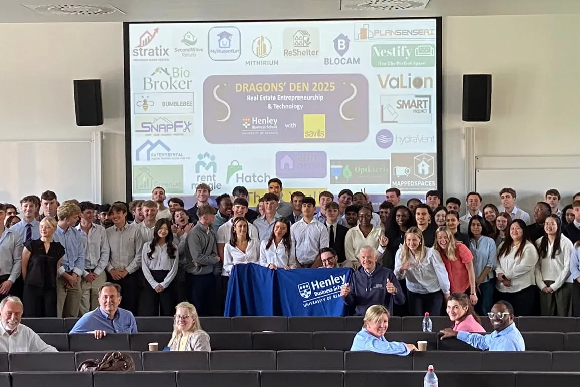 Students and industry judges gathered in a lecture theatre after Dragons’ Den 2025, with a Henley Business School banner in front of a screen showing the student team logos